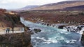 Happy Asian family tourists at hraunfossar waterfall in Iceland Royalty Free Stock Photo