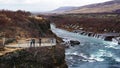 Happy Asian family travelers at hraunfossar waterfall in Iceland Royalty Free Stock Photo