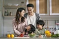 happy asian family with two children in kitchen at home Royalty Free Stock Photo