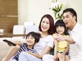 Happy asian family watching TV at home Royalty Free Stock Photo