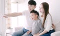 Happy Asian family watching TV together at home Royalty Free Stock Photo