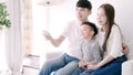 Happy Asian family watching TV together at home Royalty Free Stock Photo