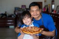 Happy asian father and daughter preparing homemade pizza Royalty Free Stock Photo