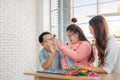 Happy asian father and mother playing education toy with their daughter down syndrome child in living room, Dad giving high-five Royalty Free Stock Photo