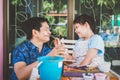 Happy asian Father `s day.Funny smiling father and her daughter painting and drawing with watercolor Royalty Free Stock Photo