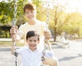 Happy father and son playing swing Royalty Free Stock Photo