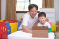 Happy Asian father and son with tablet computer are making video call to mother or relatives at home, Family spend time on Royalty Free Stock Photo