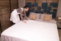 Young Asian Female Chambermaid Making Bed In Hotel Room Royalty Free Stock Photo