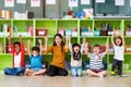 Happy Asian female teacher and mixed race kids in classroom,Kindergarten pre school concept Royalty Free Stock Photo