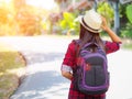 Happy Asian girl backpack in the road and forest background Royalty Free Stock Photo