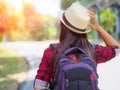 Happy Asian girl backpack in the road and forest background Royalty Free Stock Photo