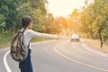 Happy Asian girl backpack in the road and forest background Royalty Free Stock Photo