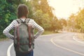 Happy Asian girl backpack in the road and forest background Royalty Free Stock Photo