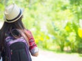 Happy Asian girl backpack in the road and forest background, Royalty Free Stock Photo