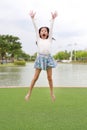 Happy Asian girl child jumping in the garden outdoor Royalty Free Stock Photo