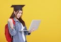 Happy Asian girl college student in Graduation cap  and holding laptop Royalty Free Stock Photo