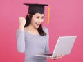 Happy Asian girl college student in Graduation cap  and holding laptop Royalty Free Stock Photo