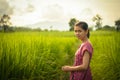 Happy Asian girl enjoy in green rice field, countryside of Thailand at sunset Royalty Free Stock Photo