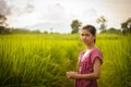 Happy Asian girl enjoy in green rice field, countryside of Thailand at sunset Royalty Free Stock Photo