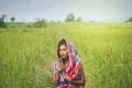 Happy Asian girl enjoy in green rice field, countryside of Thailand at sunset Royalty Free Stock Photo