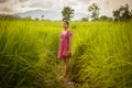 Happy Asian girl enjoy in green rice field, countryside of Thailand at sunset Royalty Free Stock Photo