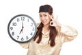 Happy Asian girl with eye mask and clock show OK sign Royalty Free Stock Photo