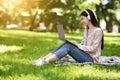 Happy Asian Girl Freelancer Working On Laptop In Park And Listening Music Royalty Free Stock Photo