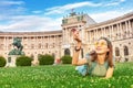 asian girl on a grass lawn playing with toy airplane, as symbol of travelling and transportation for tourists