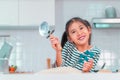 Happy girl having fun preparing pizza dough in kitchen and smile for funny child activity concept Royalty Free Stock Photo