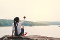 Happy Asian girl holding paper rocket in nature