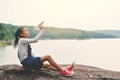 Happy Asian girl holding paper rocket in nature