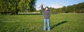 Happy asian girl, musician with ukulele, feeling carefree, enjoying freedom and fresh air outdoors, playing musical Royalty Free Stock Photo