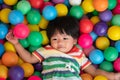 Happy Asian girl one and half years olds playing little colorful balls in pool ball. The concept of playing is the best learning Royalty Free Stock Photo