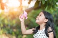 Happy asian girl playing gun bubble soap at home Royalty Free Stock Photo