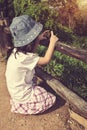 Happy asian girl relaxing outdoors, travel on vacation. Vintage Royalty Free Stock Photo