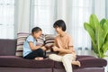 Happy Asian girl with sister playing fight teddy bears