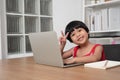 Happy Asian girl student online learning class from a computer with a teacher, online education is a technology for social Royalty Free Stock Photo