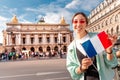 Asian girl traveler with french flag near the main Facade of the Opera Garnier in the historic building of the Academy of Royalty Free Stock Photo