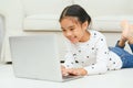 Happy Asian girl using laptop computer, concept for kid`s art and home school Royalty Free Stock Photo