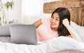 Happy Asian Girl Using Laptop Lying In Bed At Home Royalty Free Stock Photo