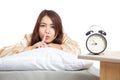 Happy Asian girl wake up show quiet sign with alarm clock Royalty Free Stock Photo