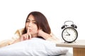 Happy Asian girl wake up show quiet sign with alarm clock Royalty Free Stock Photo