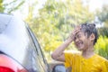 Happy Asian girl washing car on water splashing and sunlight at home Royalty Free Stock Photo