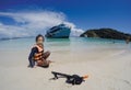 Happy asian girl wear life jacket,mask and snorkel,enjoy playing sand on the beach,tourist attractions at Koh Chang,Trat,Thailand