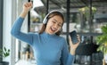 Happy Asian girl wearing headphones listening to music enjoy on smartphone digital. relaxation concepts Royalty Free Stock Photo