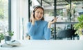 Happy Asian girl wearing headphones listening to music enjoying on smartphone digital. relaxation concepts Royalty Free Stock Photo