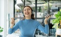 Happy Asian girl wearing headphones listening to music enjoying on smartphone digital. relaxation concepts Royalty Free Stock Photo