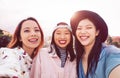 Happy Asian girls taking selfie with mobile smartphone outdoor - Young social friends having fun taking self photos outside