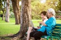 Happy asian granddaughter enjoy smiling and senior grandmother with laptop computer,child girl watching something or teaching and Royalty Free Stock Photo