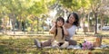 Happy Asian grandmother picnicking with her lovely granddaughter in park together. leisure and family concept Royalty Free Stock Photo